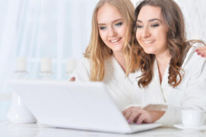 portrait-of-two-young-girls-with-laptop